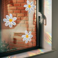 the sun is shining through the window with flowers on it