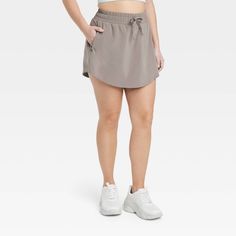 Why we're ALL IN: Woven mid-rise skort with built-in shorts in a regular-fit silhouette makes a cool choice for your active days. Moisture-wicking, quick-dry lightweight fabric helps you stay cool, while a drawcord elastic waistband provides a snug fit. Side pocket provides hands-free convenience and the UPF 50+ rating offers sun protection. All in Motion™: Made for every move, priced for every day. Casual Activewear With Built-in Shorts Above Knee, Casual Skort With Built-in Shorts For Running, Casual Short Skort For Running, Casual Running Skort, Casual Nylon Skort With Go-dry Technology, Casual Nylon Activewear With Short Inseam, Sporty Athletic Shorts For Spring Outdoor Activities, Sporty Athletic Shorts For Spring, Casual Nylon Activewear