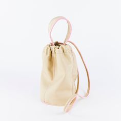 Soft leather bucket bag. Carry by the short handle or switch it out for a long shoulder strap. Leather Bucket Bag With Round Handle For On-the-go, Beige Bucket Bag With Round Handle For Shopping, Cream Bucket Satchel, Everyday Bucket Bag With Adjustable Strap And Round Handle, Cream Bucket Bag With Removable Pouch For On-the-go, Beige Bucket Bag With Detachable Strap For On-the-go, Cream Bucket Satchel With Detachable Strap, Beige Bucket Bag With Detachable Strap, Cream Crossbody Bucket Bag With Removable Pouch