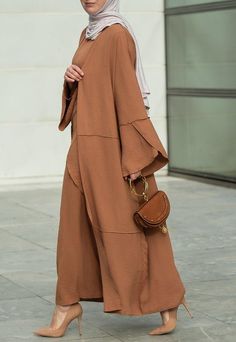 Introducing the Deluna three piece maxi lightweight abaya in rustic brown. This elegant and versatile design is perfect for any season and includes a long sleeve slip dress, apron piece, and a throw over abaya. The fabric is specially designed to resist wrinkles and the contrast brown color overlook seam at the edge of the abaya stands out.The abaya is super lightweight and flowy making it perfect for hot weather. The apron piece allows you to adjust the fit and the pattern of the abaya is not o Modest Maxi Length Abaya For Fall, Fall Season Modest Maxi Length Abaya, Fall Modest Maxi Length Abaya, Modest Long Abaya For Fall, Modest Solid Color Floor-length Abaya, Modest Floor-length Abaya, Elegant Long Thobe For Fall, Bohemian Long Sleeve Abaya For Fall, Fall Solid Color Maxi Length Abaya