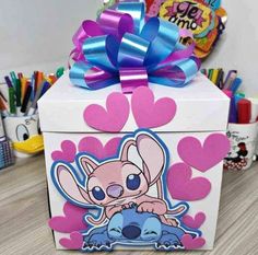 a small box with a cartoon character on it and a bow around the top that is attached