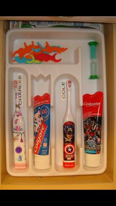 toothbrushes, toothpaste and other hygiene products are organized in a tray