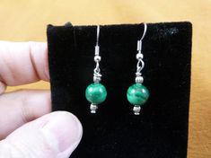 (Internal #EE701-3) This is a beautiful pair of green Malachite dangle earrings with one bead, SMOOTH ROUND 8mm malachite beads with 3mm silver alloy textured round accent beads, on silver alloy hypoallergenic French wires.  This is a nice pair of earrings, for a classic look.This is exactly the item you will receive.French wire dangle earrings, hypoallergenic gold color or silver color, made by Glenn.WE SHIP WORLDWIDE! Other accepted payment: Credit card (Mastercard\/Visa\/Discover) inquire for Green Wire Wrapped Round Earrings, Teeth Jewelry, Earrings Hypoallergenic, Silver Caps, Green Malachite, Wire Pendant, French Wire, Beaded Jewelry Diy, Silver Wire