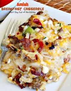 a white plate topped with breakfast casserole next to a fork