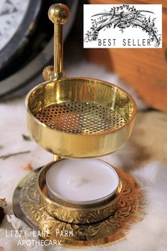 a candle holder sitting on top of a table next to a clock and other items