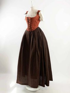 Transport yourself to a bygone era with our Renaissance Costume in Rust Orange and Chocolate Linen. Meticulously handcrafted with meticulous attention to detail, this ensemble is an exquisite choice for Renaissance fairs, Medieval events, or any special occasion where you seek to immerse yourself in history. The rust orange corset, fashioned from premium linen, boasts adjustable straps and a lace-up design that ensures both comfort and a personalized fit. Harmoniously complementing the corset is Brown Peasant Dress, 1400s Fashion Peasant, 1600s Dresses Peasant, 1700s Dresses Peasant, Fantasy Peasant Dress, 1600s Fashion Peasant, Victorian Peasant Dress, Medieval Peasant Clothing, Pesant Dress