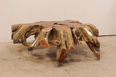 a coffee table made out of tree trunks