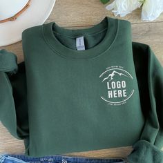 Custom Embroidered Logo Text Sweatshirt, Embroidered Business Logo Unisex Sweater, Monogram Company Name Crewneck, Logo Business Uniform Tee Looking for the perfect custom logo embroidery sweatshirt? All orders are shipped the next day and are backed by our 100% Love it Guarantee. 💚 How to Order  1) Please check all the photos from the listing. 2) Please choose your shirt size, thread color and sweatshirt color. (Sweatshirt sizes and thread colors are shown on the listing photos) 3) Add your pe Cheap Crew Sweatshirt With Team Name, Green Cotton Sweater With Logo Print, Green Embroidered Tops For Winter, Green Long Sleeve Top With Embroidered Logo, Crew Neck Tops With Embroidered Logo For Winter, Winter Crew Neck Top With Embroidered Logo, Green Embroidered Crew Top, Green Embroidered Crew Neck Top, Green Embroidered Crew Neck Sweater