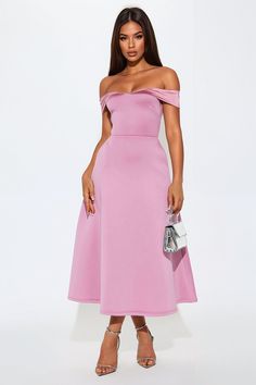 a woman is wearing a pink dress with off the shoulder and high low cut heels