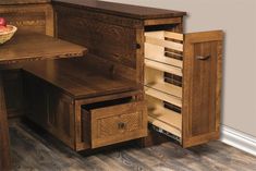 a wooden desk with drawers and a basket of fruit in it's drawer area