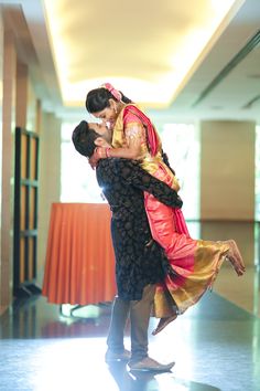 a man and woman dance together in an empty room