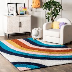 a living room with a rug, chair and potted plant