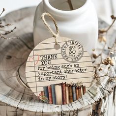 a wooden bookmark with an image of books on it and the words thank you for being such an important character in my story