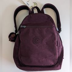 Detachable Monkey Keychain, Multiple Compartments, Padded Adjustable Backpack Straps, Top Carry Handle, Interior Zip Pouch. Dimensions: 10.25 W X 14.5 H X 8.25 D Approx Zip Closure 1 Interior Slip Pocket, 1 Interior Pen Slot, 2 Exterior Zip Pockets Color: Dark Plum Tonal Smoke Free Home Fall Backpack, Preppy Backpack, Rolling Backpack