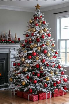 a white christmas tree with red and gold ornaments