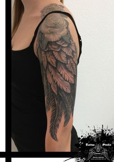 a woman with a black and grey owl tattoo on her arm