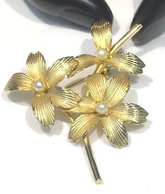 This very pretty vintage brooch satin gold tone textured flower petals with faux pearls (could very well be cultured)  The brooch measures 2" x 1.75" with a roll over clasp and is in very good vintage condition with the satin gold tone finish nice.  Unsigned and weighs 7 grams  Shipping prices vary on the weight of item. I do my best to keep shipping costs reasonable. The prices quoted are not trackable and is the least expensive airmail postage for most countries. If you want tracking, the cost Gold Flower Brooch For Formal Occasions, Elegant Gold Brooches For Spring, Gold Flower Brooch For Evening, Gold Brooches For Spring Gift, Spring Gold Brooch Jewelry, Spring Gold Jewelry Brooch, Spring Season Gold Brooch Jewelry, Gold Brooch Jewelry For Spring, Floral Brooch