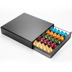 a black box filled with lots of colorful candies on top of a white table