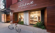 a bike is parked in front of a store with the name alchemie on it