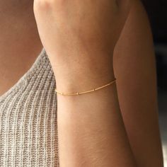 Minimal and modern, our satellite bracelet is perfect for layering. Single, double layered or matched with your other bracelets will make a statement for any occasion. P R O D U C T * D E T A I L S  - Wire wrapping detail - Available in Sterling Silver, 14k Gold Filled or 14k Rose Gold Filled L E N G T H - Model is wearing Gold bracelet - This bracelet is measured opened from end to end  - Not sure what length to get? Step 1: Use a string to mark the spot you would like your bracelet Step 2: Mea Everyday Chain Bracelet With Round Beads, Minimalist Chain Bracelet With Tiny Beads, Dainty Beaded Bracelets With Satellite Chain, Dainty Satellite Chain Bracelet For Everyday, Minimalist Beaded Bracelets With Satellite Chain, Dainty Beaded Bracelet With Satellite Chain, Adjustable Minimalist Satellite Chain Bracelet, Modern Bracelets With Satellite Chain, Minimalist Satellite Chain Bracelet With Round Beads