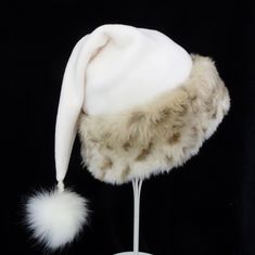 Santa hat is made up in a cozy poly fleece cream fabric and trimmed with a quality soft and thick snow leopard faux fur trim. Hat is styled in the traditional Santa slouch style stocking hat and is generously sized to fit most teen and adult head sizes. Measurement of the hat band is 24-25" circumference and the length of the hat is 20". and there is a fluffy faux fur pompom dangle stitched on the tip. Check measurements to make sure this size will work for you.  Custom orders for size will depend on fabric availability at the time of your request. Christmas Party Hat, Christmas Party Hats, Santa Costume, Stocking Hat, Santa Claus Hat, Earring Storage, Faux Fur Pom Pom, Costume Hats, Snow Leopard