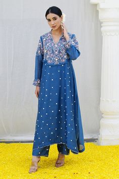 Jean blue kurta features a heavily embroidered jaal on the yoke enhanced with organza rosettes, sprinkled with dori dots all over. Paired with embroidered palazzo.
Components: 2
Pattern: Embroidered
Type Of Work: Resham
Neckline: Cutwork
Sleeve Type: Long
Fabric: Banaras Silk Base
Color: Blue
Other Details: 
Lace detail
Floral applique
Note: Kindly contact customer service for embroidered dupatta
Occasion: Mehendi and Haldi - Aza Fashions Blue Embroidered Long Sleeve Palazzo Set, Blue Resham Embroidered Designer Dress, Designer Blue Dress With Resham Embroidery, Blue Georgette Dresses With Floral Embroidery, Blue Embroidered Dress For Designer Wear, Unstitched Blue Chikankari Embroidery Dress, Blue Chikankari Embroidery Designer Dress, Blue Semi-stitched Dress With Intricate Embroidery, Blue Embroidered Semi-stitched Dress For Wedding