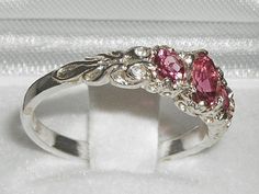 *This lovely ring is made from 375 9K White Gold with Genuine Natural Semi-precious Pink Tourmalines.*Total gem weight: 0.9ctGenuine Natural Pink Tourmaline - One center oval cut 6x4 mm (0.24" x 0.16") and two round cut 4mm (0.16") Pretty Pink Tourmalines set in this Solid 9K White Gold Victorian style setting.*Total Height 3mm, Width 20mm, Length 7mmCompletely made from Solid 9K Gold Hallmarked by the London Assay Office which confirms the rings authenticity. The Hallmark includes the 375 marki Gold Ring Pink Stone, Pink And Silver Ring, Pink Stone Wedding Ring, Pink And Green Ring, Classic Pink Three Stone Jewelry, Pink Three-stone Round-cut Jewelry, Tourmaline Three-stone Ring As A Gift, Tourmaline Three-stone Ring Perfect For Gifting, Tourmaline Three Stone Ring Perfect As A Gift