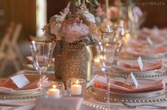 the table is set with pink and white flowers