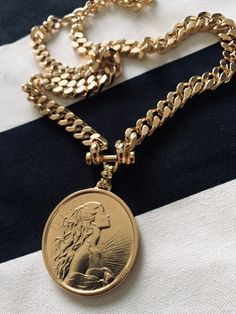 "⚜️NEW COLLECTION 2023⚜️ ✨EXPRESS SHIPPING OVER 100$ FREE Item Overview Handmade item Made to order. DETAILS High quality 2 micron 24k gold micron plating Lead Free and Nickel Free MEASURES Coin size: 40mm / thickness 4 mm Chain width- 7-8 mm GODDESS CURB NECKLACE Can goes along your favorite necklace you wearing daily for \" layered\" look or just by it self for \"clean\" and classy look. As a gift , will be beautiful for your best friend birthday, sister wedding, mom anniversary or your lovely Chunky Chain Costume Jewelry Necklace As Gift, Costume Jewelry Necklace With Chunky Chain For Gift, Vintage Gold Metal Coin Necklace, Vintage Brass Clavicle Chain Jewelry, Chic Gold Necklace With Curb Chain, Chic Gold Cuban Link Necklace, Chic Chunky Cuban Link Chain Necklace, Chic Cuban Link Chunky Chain Necklace, Chic Necklaces With Chunky Cuban Link Chain