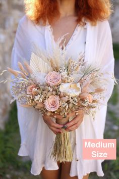 a woman holding a bouquet of flowers in her hands with the words medium size on it