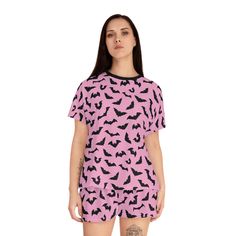 Unleash your inner goth queen with these adorable Pink Bats women's pyjamas. Made for comfort, this set features a short sleeve t-shirt and matching shorts - perfect for those warm nights! With the unique pastel goth design. Black bats on a pastel pink background, bringing together spooky and cute in one stylish package. Sleep never looked this good! Why pick between comfort or style when you can have both? These women's short pajama two-piece set come with a relaxed fit, a ribbed collar and fea Cute Cotton Halloween Sleepwear, Cute Halloween Pajama Party Sleepwear, Cute Halloween Sleepover Sleepwear, Black Halloween Sleepwear For Sleepover, Goth Pajamas, Goth Design, Goth Queen, Bats Halloween, Disney Pajamas