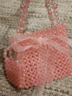 You will fall in love with this peach beaded bag. Glowing beads are used . Looks pretty in sunlight as well as in dark. It comes with a sling of 95 cm. Easy to keep mobile and small accessory.  It comes with beautiful Jute Cover with logo. Best gift for any Girl or lady. Size 15cm by 14cm . 8 Cm handles . Pink Shoulder Bag With Pearl Handle, Summer Pink Beaded Bag, Pink Shoulder Bag With Pearl Handle For Fashion, Pink Beaded Party Shoulder Bag, Pink Beaded Shoulder Bag For Party, Summer Pink Beaded Shoulder Bag, Pink Rectangular Shoulder Bag With Pearl Handle, Elegant Pink Shoulder Bag For Beach, Pink Beaded Bag For Everyday Use