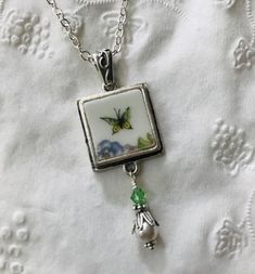 "Broken China Jewelry, Jewelry Theodore Haviland Limoges Butterfly Square Pendant Necklace Made from a Vintage Theodore Haviland Limoges China Plate, Circa 1940 Pendant Measures 3/4\" X 2\", including Pearl and Crystal Dangle Includes Antiqued Sterling Bail and 18\" Silverplated Chain This listing is for a hand-crafted, \"broken china\" necklace. This piece has been created by artistically repurposing a vintage Haviland Limoges china plate. What a perfect little piece of jewelry to liven up your Vintage Square Pendant Jewelry For Anniversary, Vintage Nickel-free Square Pendant Jewelry, Vintage Square Pendant Jewelry, Square Pendant Necklace, Limoges China, Broken China Jewelry, China Jewelry, Broken China, Square Pendant