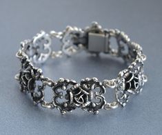 A beautiful massive three dimensional 835 silver roses link bracelet, partially oxidised, German origin. Length 19 cm (7.5"), Width 2 cm (0.8") Weight 44 grams Hallmarked: 835 for European silver and maker's mark Excellent vintage condition, the bracelet is closing securely. Will be delivered by tracked and signed mail. Thank you for looking. Please see my other items. Vintage Silver Jewelry With Roses, Elegant Silver Bracelets With Rose Design, Elegant Silver Bracelet With Rose Design, Formal Silver Jewelry With Rose Details, Maker's Mark, Bracelet Argent, Last Minute Gifts, Silver Roses, Lithuania