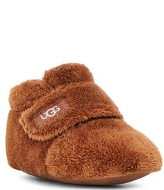 From UGG &#x2C; the Kids' Bixbee Washable Slip-On Crib Shoes feature: Cozy textile upperMachine washableAdjustable hook-and-loop closure for easy on and offCozy textile liningFaux suede outsole with printed silicone treadImported. Baby Ugg Slippers, Crib Shoes Girl, Ugg Booties, Ugg Kids, Baby Uggs, Shearling Slippers, Ugg Slippers, Kids Uggs, Shearling Boots