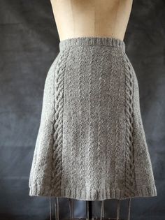 a mannequin wearing a skirt made out of knitted material, back view