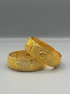 Our 24k Polished Bangles are more than just accessories; they are symbols of grace and beauty, inspired by the rich heritage of Indian, Pakistani, and Nepali jewelry. These stunning bangles showcase the timeless elegance of traditional craftsmanship, perfectly complementing your attire for weddings, festivals, or any special occasion Our company offers expedited Next-Day Delivery Services within the United Kingdom, ensuring prompt and efficient transportation of goods.  Additionally, we strive to extend our shipping capabilities to cater to customers worldwide, aiming to provide the fastest possible shipping methods to international destinations. To ensure the highest standards of hygiene, we kindly request your understanding that all sales are final, and we are unable to accept returns or Traditional Bangle With Elegant Design As Gift, Elegant Gold Plated Bangle For Festivals, Elegant Bangle With Intricate Design For Diwali, Elegant Gold-plated Openable Bracelets, Elegant Gold Plated Openable Bracelets, Traditional Yellow Gold Bangle, Festive 22k Gold Elegant Bracelets, Elegant Diwali Bangle With Intricate Design, Elegant Yellow Gold Bangle For Ceremonial Occasions