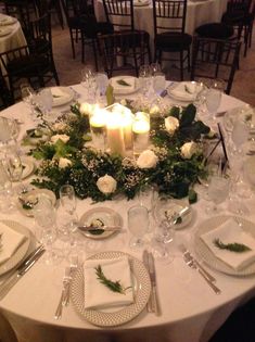 the table is set with candles and place settings