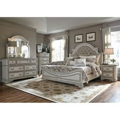 a bedroom with a bed, dresser and mirror