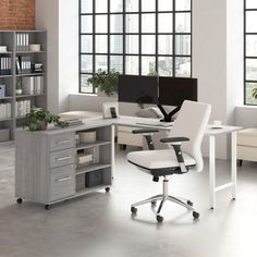 an office with two desks and a chair in front of the computer monitor on the desk