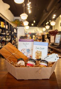 a wooden table topped with a box filled with food