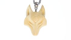 a wooden wolf head pendant on a chain