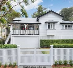 a house with white picket fence surrounding it