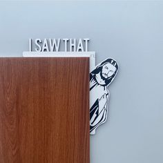 a wooden door with the words i saw that on it next to a sticker