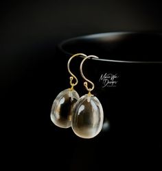 These are the ultimate everyday earrings! Just the thing to grab on the way out the door for that added sparkle and will go with everything in your wardrobe. These gems are truly amazing in person...like liquid pools of light. They are all natural, the finest specimens available, with the utmost luster and superb clarity. These 3 dimensional full egg shaped drops require the finest roughs to manufacture into these stunning beauties. As with this particular cut, the inclusions would be greatly ma Handmade Briolette Earrings For Formal Occasions, Modern Gold Briolette Earrings, Gold Briolette Earrings For Formal Occasions, Formal Clear Teardrop Earrings, Gold Briolette Single Earring, Elegant Teardrop Clear Earrings, Elegant Clear Teardrop Earrings, Elegant Clear Pierced Jewelry, Clear Long Drop Earrings For Gift