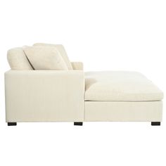 a white chaise lounge chair and ottoman