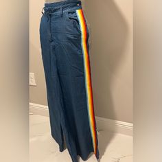 Hot And Delicious Wide Leg Denim Pants With Rainbow Colored Side Piping . Material Is Soft . No Stretch . Runs Small 70% Tencel 30% Cotton High Waist Multicolor Denim Pants, Multicolor Straight Leg Denim Pants, Casual Rainbow Pants For Spring, High Rise Multicolor Cotton Pants, Multicolor High Rise Cotton Pants, Multicolor High-rise Cotton Pants, Multicolor High Rise Denim Bottoms, Casual Fitted Rainbow Bottoms, Casual Rainbow Cotton Bottoms