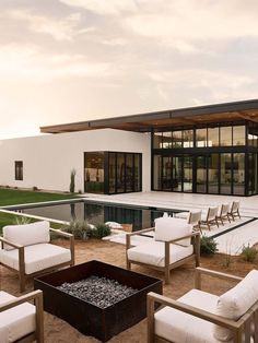 an image of a modern house with pool and patio furniture in the front yard area