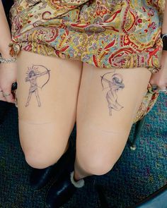 two women with tattoos on their butts sitting next to each other