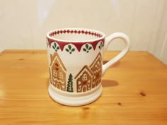 a coffee cup decorated with houses and trees